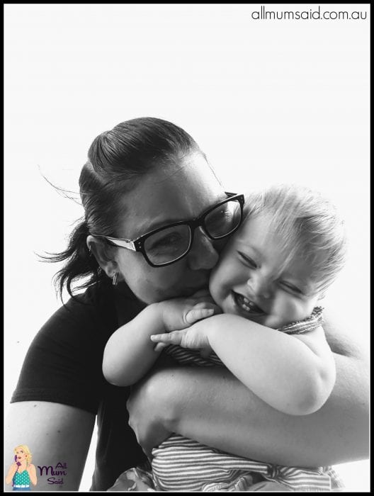 mum and toddler laughing while hugging