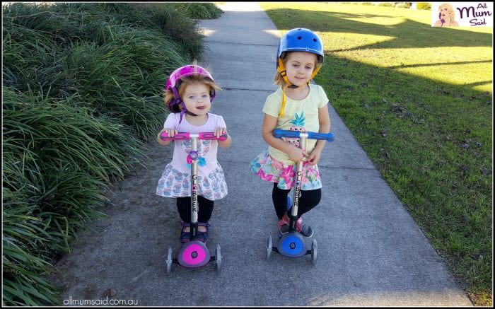 girls riding Globber scooters with flashing lights