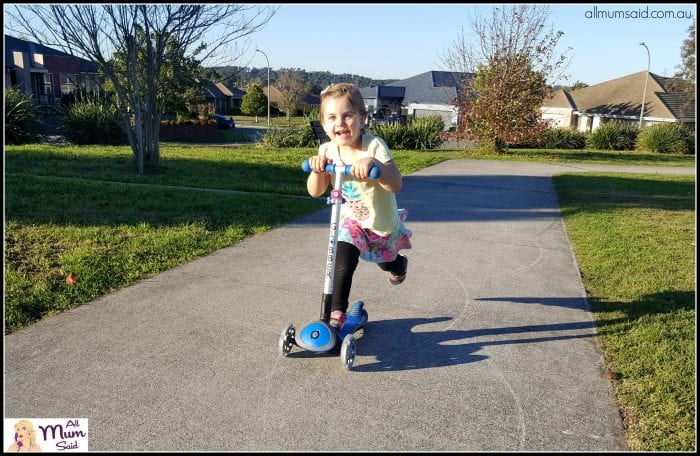 preschooler on globber scooter with flashing wheels at park