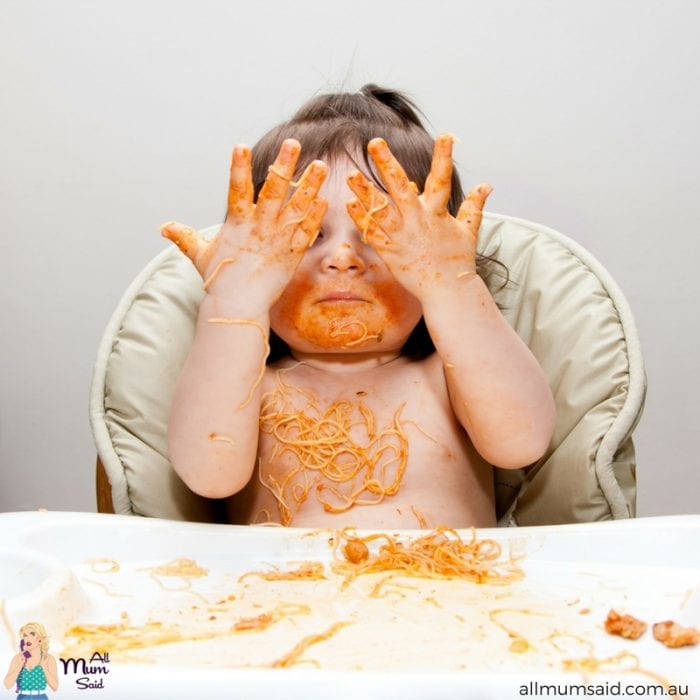 Toddler eating messy spaghetti