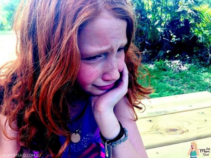 crying child girl sitting outside