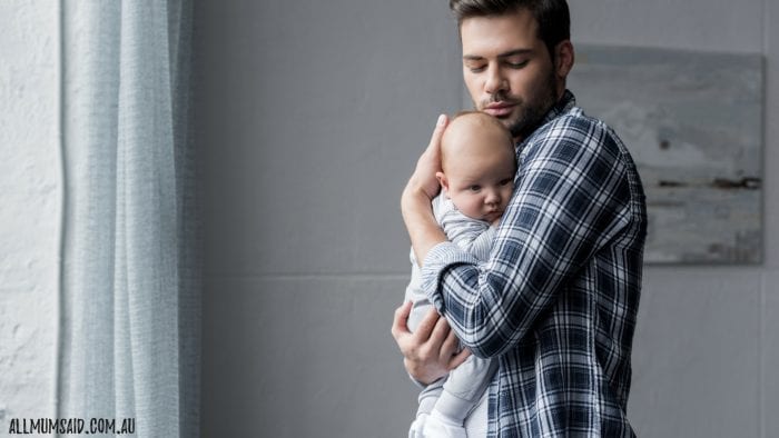 dad holding baby in parents room
