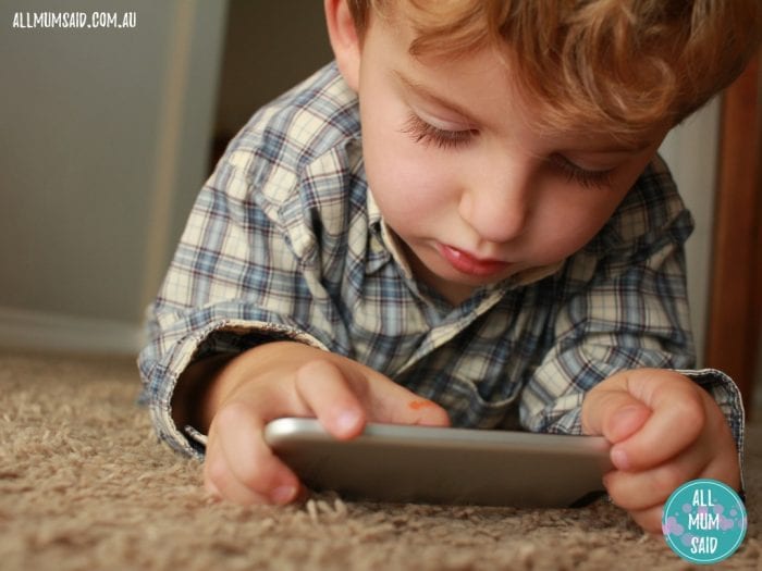 Tips to reduce screen time | young boy playing with phone